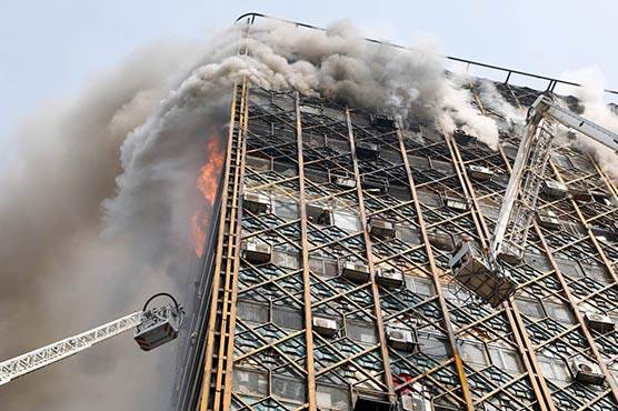 Collapsed building in Tehran traps dozens of firefighters